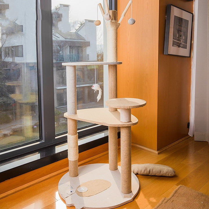 MATERA PET modern cat tree in a sunny living room by the window, cream sisal posts, cloud-shaped platform and round side perch