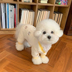 Bichon puppy wearing MATERA PET cream knit four-leg jumpsuit with yellow ribbed cuffs