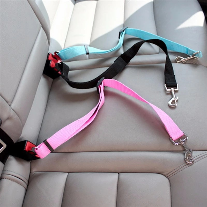 Three MATERA PET dog seat belt tethers in sky blue, black and pink on a car seat