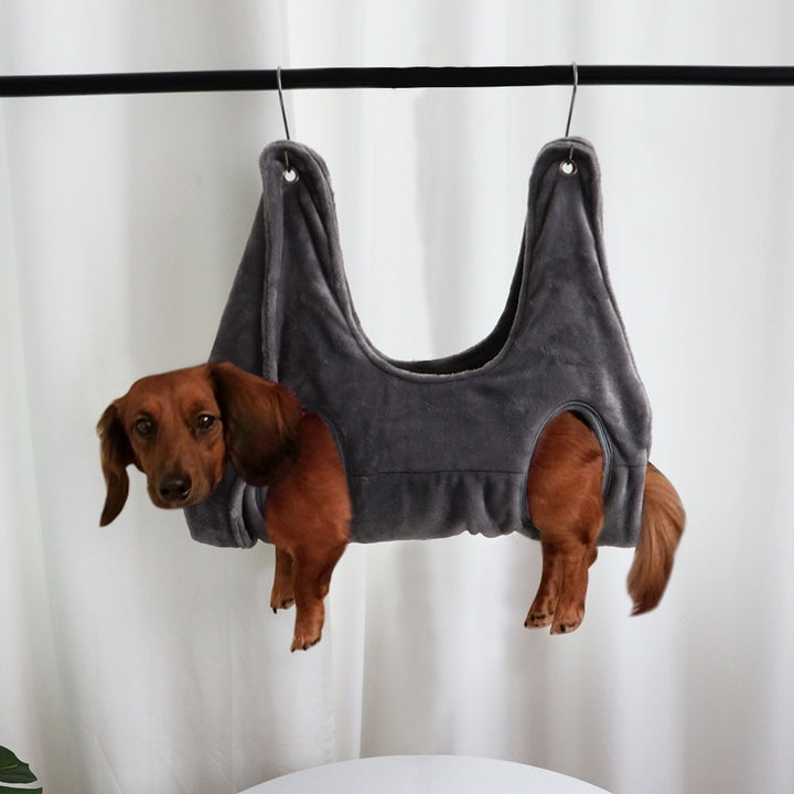 MATERA PET grey pet restraint hammock for grooming, a dachshund resting with paws hanging free