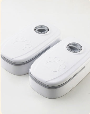 Two MATERA PET timed pet feeders in grey with closed lids and timer dials