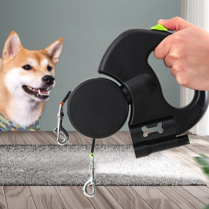 Hand holding the dual dog leash beside a shiba inu at home