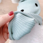 Close-up of MATERA PET polka dot dog sweater sleeve in mint, showing ribbed knit