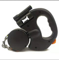 Black dual retractable dog leash showing the waste bag compartment