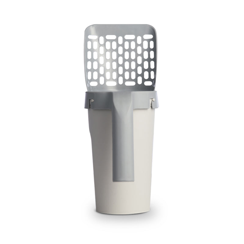 The cat litter scoop docked into its cream storage box