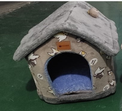 Grey paw-print pet house with blue cushion and pitched roof