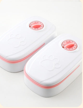 Two MATERA PET automatic pet feeders in pink showing the mechanical timer dial