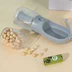 MATERA PET travel water bottle opened beside dry kibble and a roll of waste bags