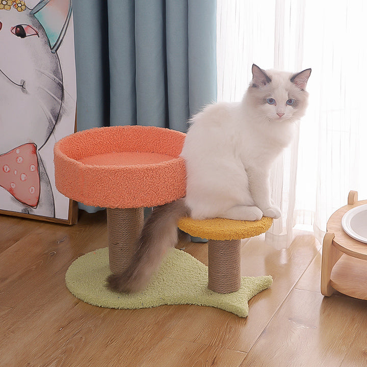 MATERA PET compact cat tree with round coral nest bed, mustard step and sisal scratching posts, white cat sitting on the step