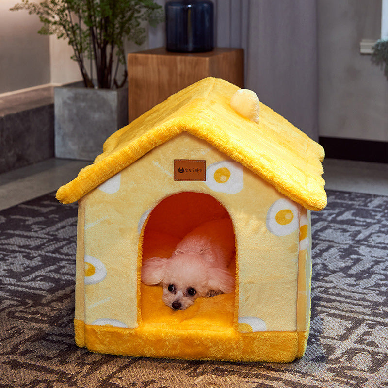 Pomeranian looking out of the yellow roof pet house bed