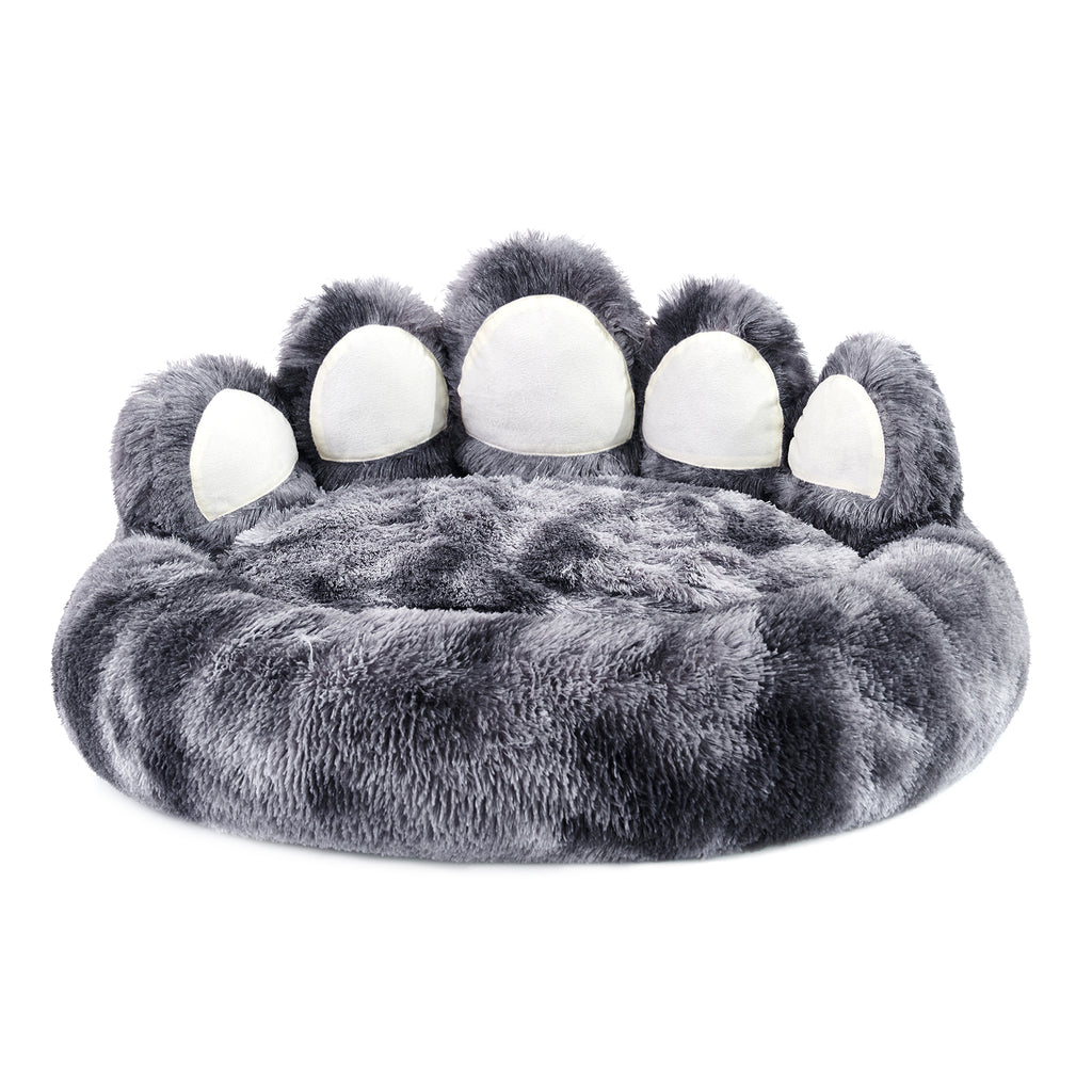 Cat curled up inside the bear paw cave bed