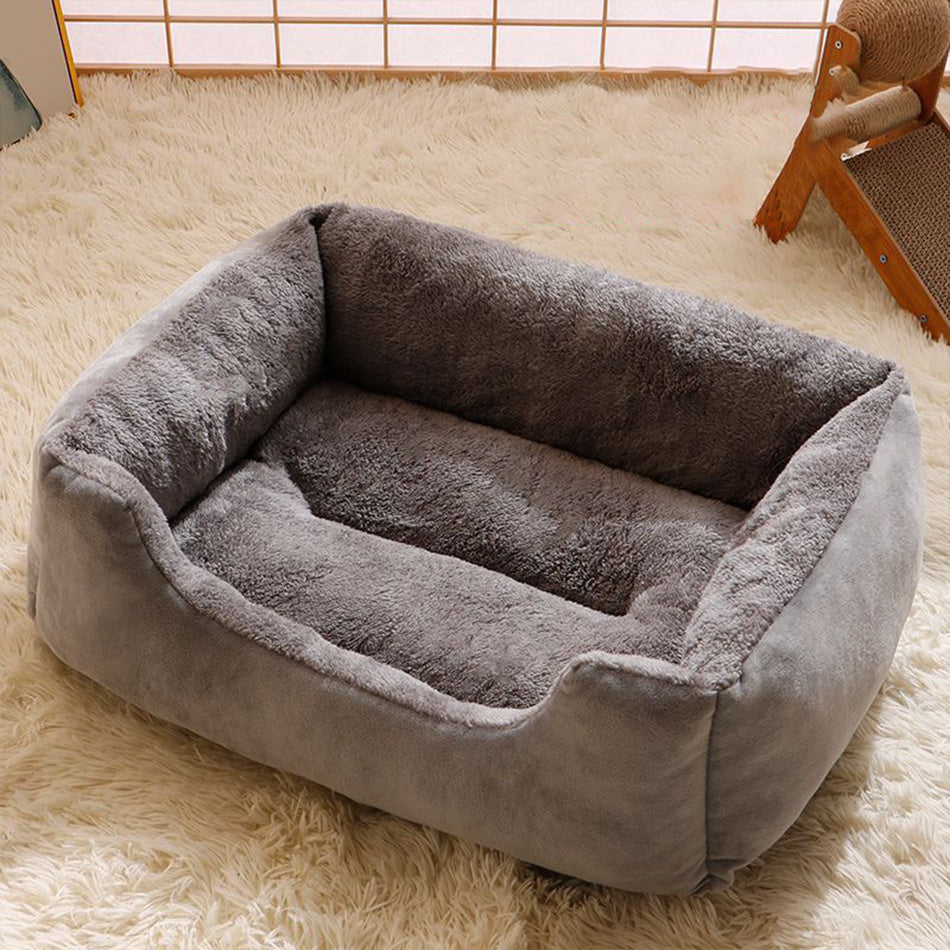 Black padded pet cushion laid flat on the floor