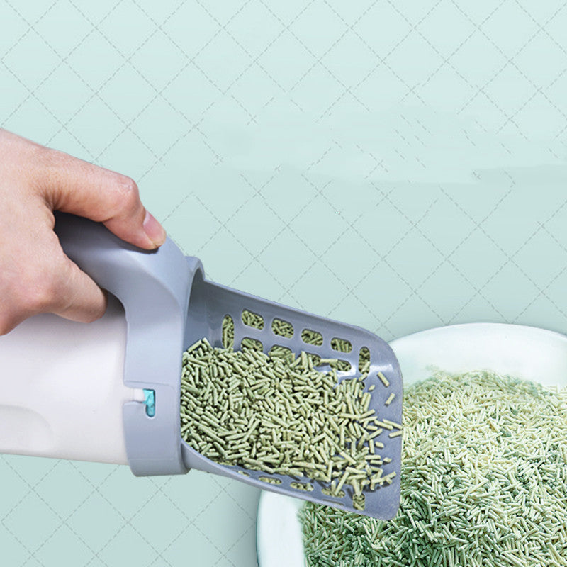 Sifting the litter tray with the slotted scoop, clean litter falling back through